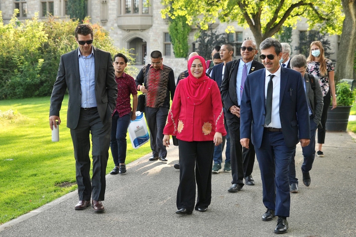 Dr. Hassan Vatanparast from the College of Pharmacy and Nutrition and School of Public Health (right) leads Dr. Ahmad (center) and the UMT delegation on a tour of campus. 
